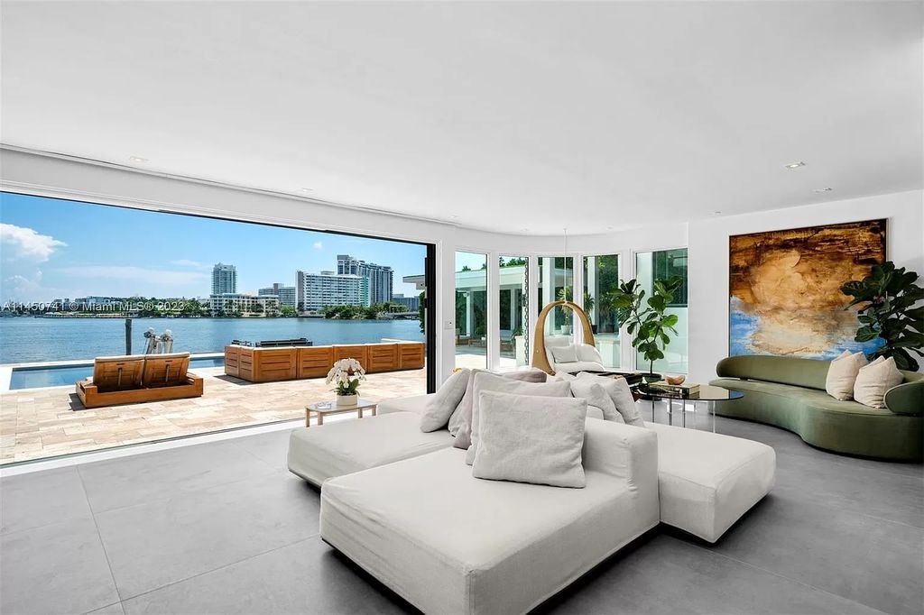 This magnificent waterfront property in Miami Beach, FL offers 90 feet of pristine water frontage, breathtaking views, and direct access to the beautiful waterways of Miami. The home features an open floor plan, a new summer kitchen with a Brazilian-style BBQ and pizza oven, gas fireplaces poolside and dockside, a custom 4-car garage, and more.