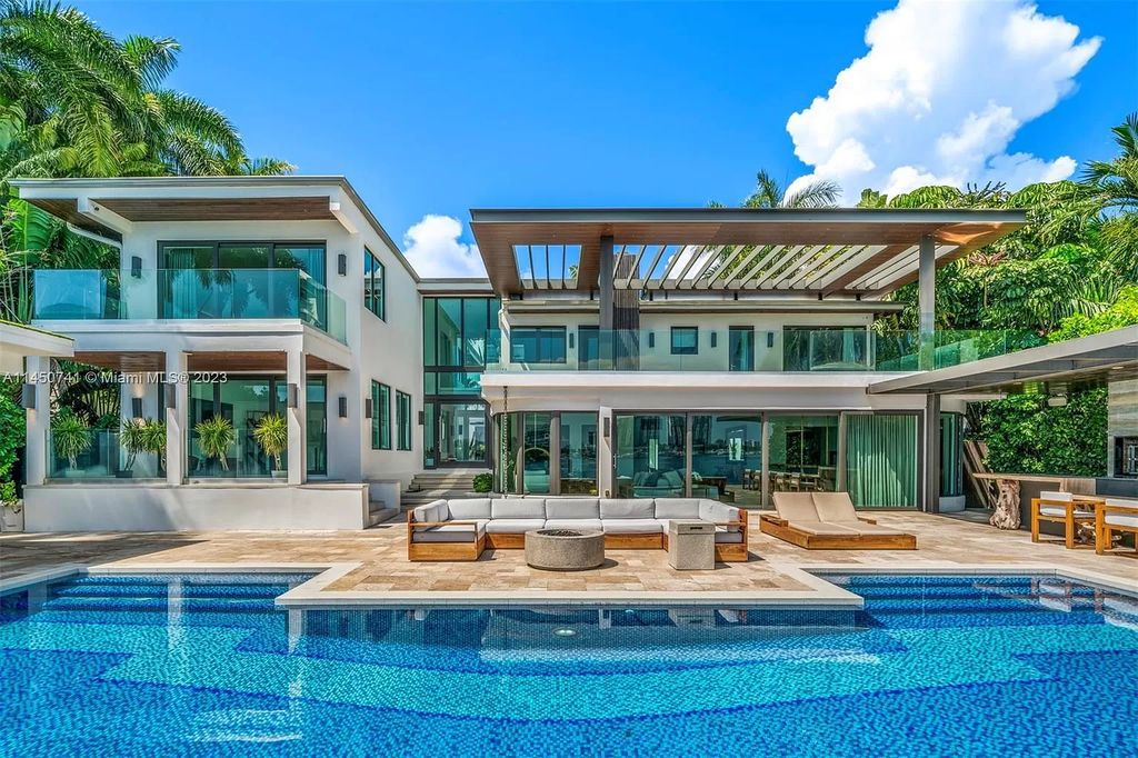 This magnificent waterfront property in Miami Beach, FL offers 90 feet of pristine water frontage, breathtaking views, and direct access to the beautiful waterways of Miami. The home features an open floor plan, a new summer kitchen with a Brazilian-style BBQ and pizza oven, gas fireplaces poolside and dockside, a custom 4-car garage, and more.