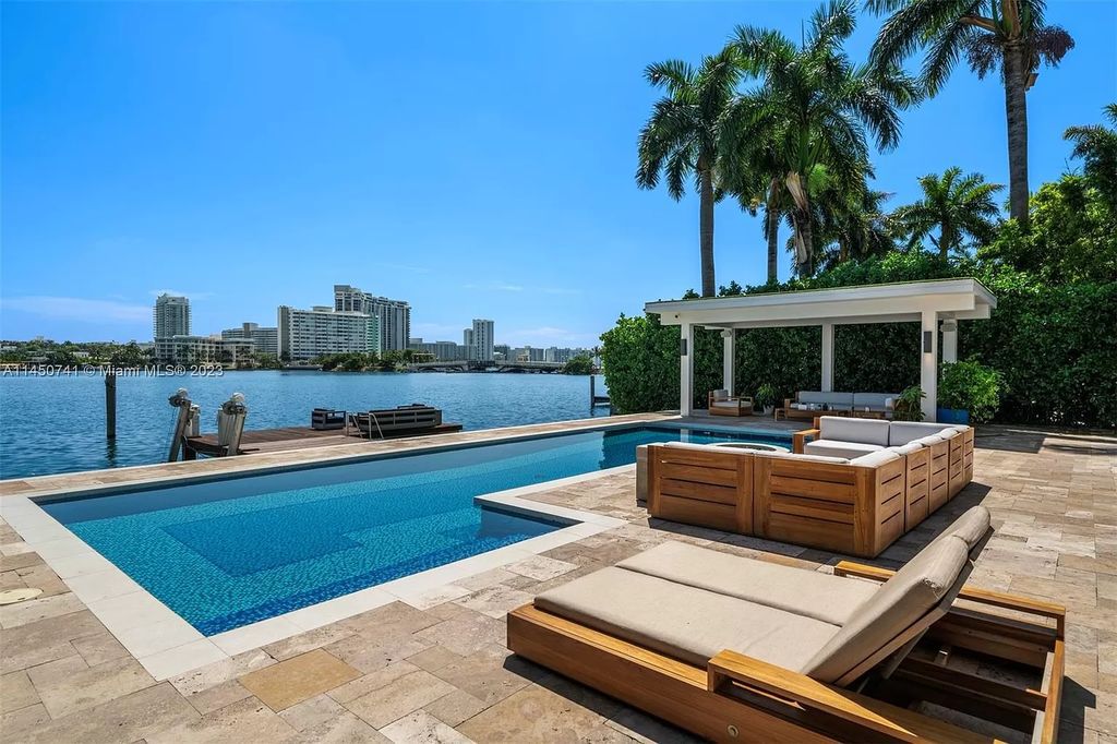 This magnificent waterfront property in Miami Beach, FL offers 90 feet of pristine water frontage, breathtaking views, and direct access to the beautiful waterways of Miami. The home features an open floor plan, a new summer kitchen with a Brazilian-style BBQ and pizza oven, gas fireplaces poolside and dockside, a custom 4-car garage, and more.