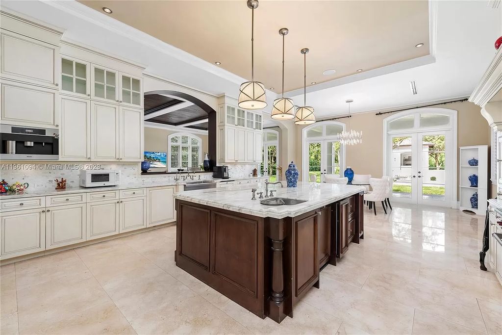 This stunning palatial Neoclassical estate in Coral Gables is the perfect entertainer's dream, with an enormous entertainment wing, movie theater, private guest suite, and resort-style amenities. The 4000sf master wing features a gym, dual closets, luxurious bathroom, large sitting room/office, and expansive terraces. Also includes separate staff/in-law quarters, oversized garages for 6 cars, and access to a 40ft boat slip in Snapper Creek Marina.