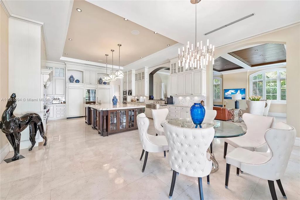 This stunning palatial Neoclassical estate in Coral Gables is the perfect entertainer's dream, with an enormous entertainment wing, movie theater, private guest suite, and resort-style amenities. The 4000sf master wing features a gym, dual closets, luxurious bathroom, large sitting room/office, and expansive terraces. Also includes separate staff/in-law quarters, oversized garages for 6 cars, and access to a 40ft boat slip in Snapper Creek Marina.