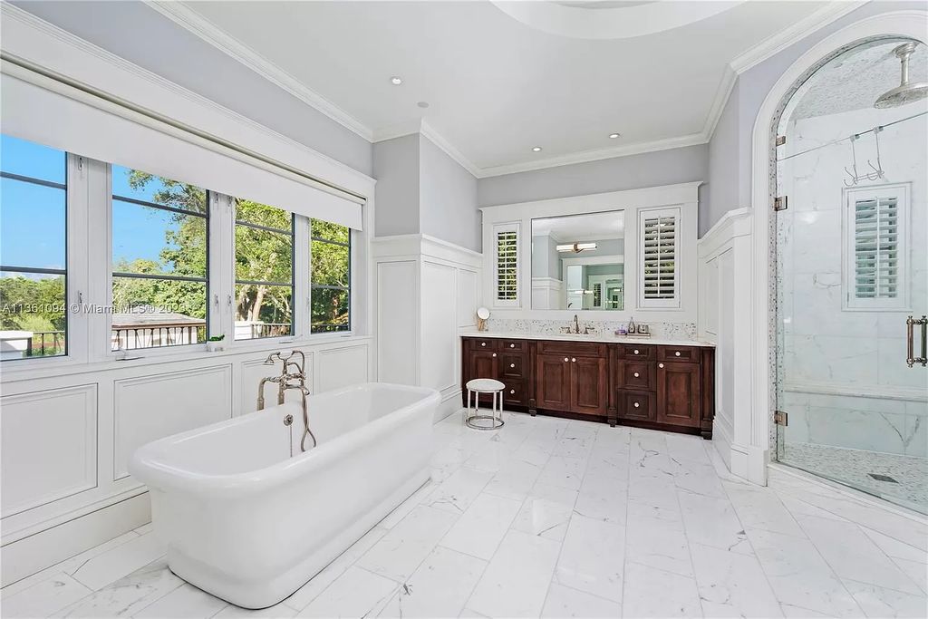 This stunning palatial Neoclassical estate in Coral Gables is the perfect entertainer's dream, with an enormous entertainment wing, movie theater, private guest suite, and resort-style amenities. The 4000sf master wing features a gym, dual closets, luxurious bathroom, large sitting room/office, and expansive terraces. Also includes separate staff/in-law quarters, oversized garages for 6 cars, and access to a 40ft boat slip in Snapper Creek Marina.