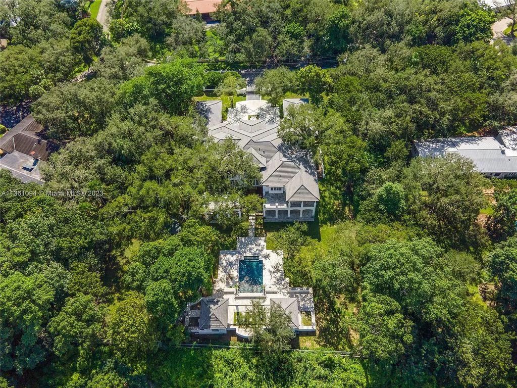 This stunning palatial Neoclassical estate in Coral Gables is the perfect entertainer's dream, with an enormous entertainment wing, movie theater, private guest suite, and resort-style amenities. The 4000sf master wing features a gym, dual closets, luxurious bathroom, large sitting room/office, and expansive terraces. Also includes separate staff/in-law quarters, oversized garages for 6 cars, and access to a 40ft boat slip in Snapper Creek Marina.