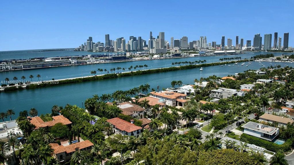 Live a life of unparalleled luxury on Palm Island. This 3-home estate boasts soaring ceilings, expansive living areas, and stunning water views. Perfect for entertaining, it features outdoor kitchens, covered lounges, and breathtaking vistas of downtown Miami. A truly unique opportunity for discerning buyers.