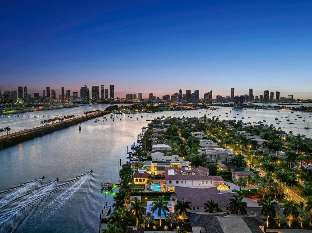 Live a life of unparalleled luxury on Palm Island. This 3-home estate boasts soaring ceilings, expansive living areas, and stunning water views. Perfect for entertaining, it features outdoor kitchens, covered lounges, and breathtaking vistas of downtown Miami. A truly unique opportunity for discerning buyers.