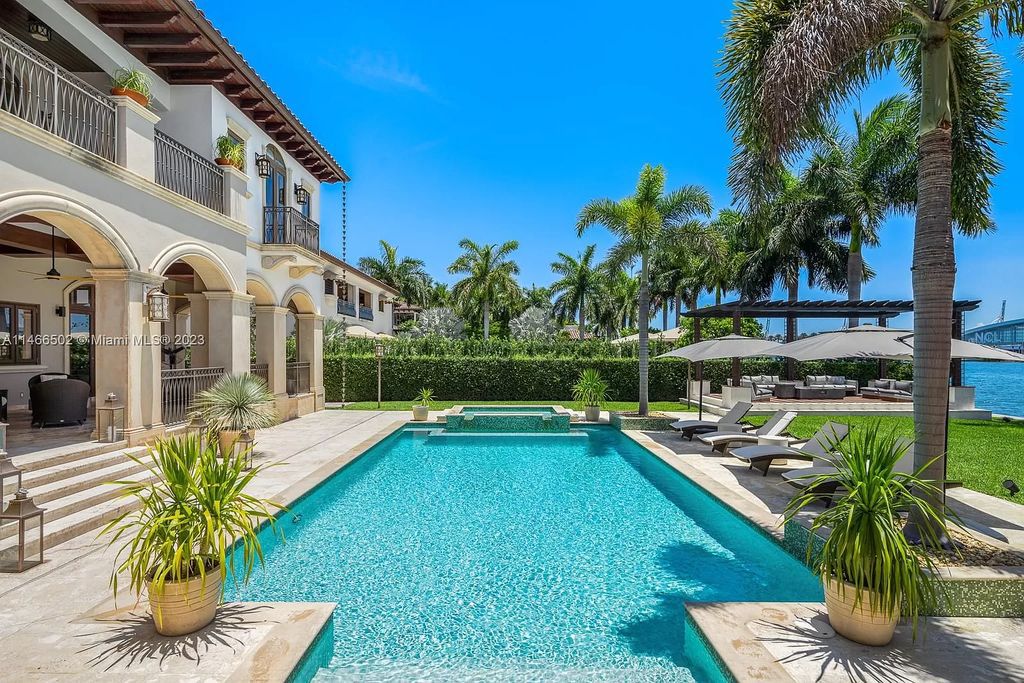 Live a life of unparalleled luxury on Palm Island. This 3-home estate boasts soaring ceilings, expansive living areas, and stunning water views. Perfect for entertaining, it features outdoor kitchens, covered lounges, and breathtaking vistas of downtown Miami. A truly unique opportunity for discerning buyers.