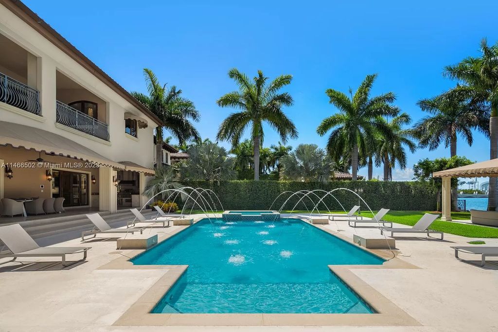 Live a life of unparalleled luxury on Palm Island. This 3-home estate boasts soaring ceilings, expansive living areas, and stunning water views. Perfect for entertaining, it features outdoor kitchens, covered lounges, and breathtaking vistas of downtown Miami. A truly unique opportunity for discerning buyers.