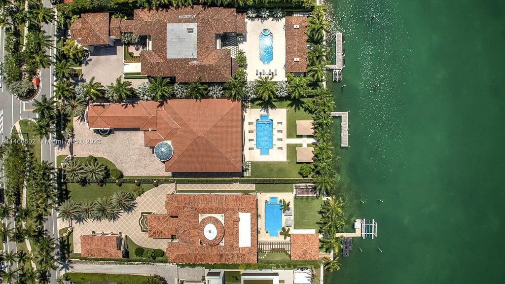 Live a life of unparalleled luxury on Palm Island. This 3-home estate boasts soaring ceilings, expansive living areas, and stunning water views. Perfect for entertaining, it features outdoor kitchens, covered lounges, and breathtaking vistas of downtown Miami. A truly unique opportunity for discerning buyers.