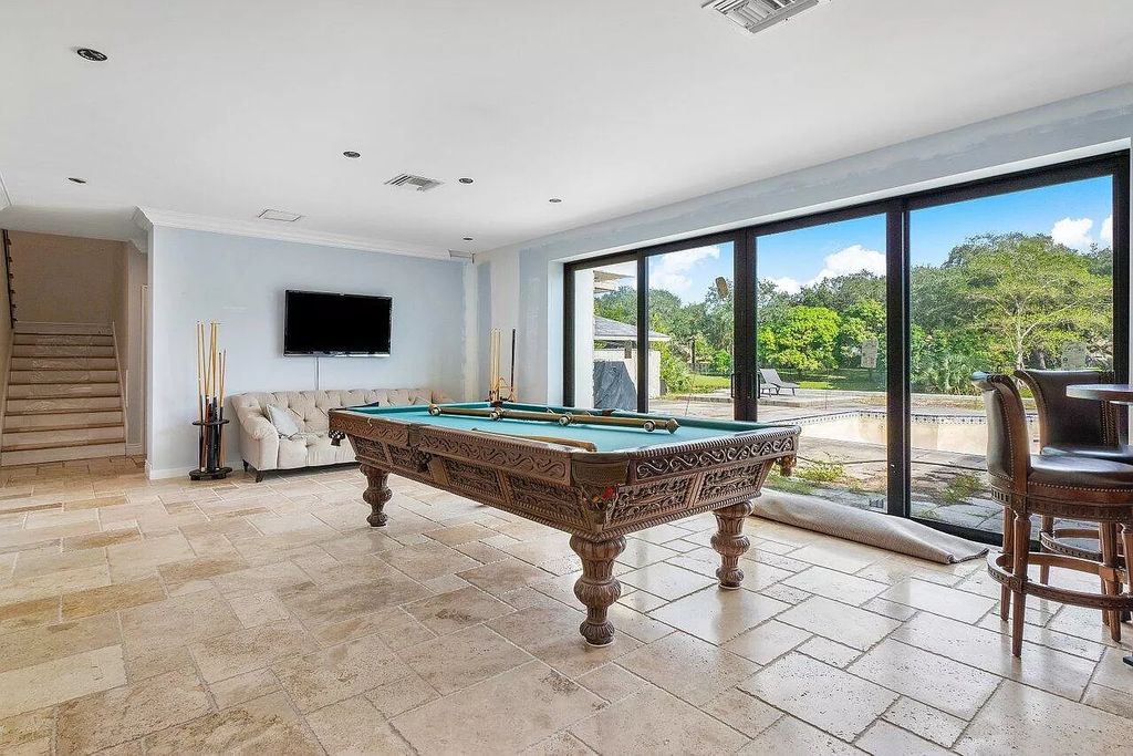 Unwind in unparalleled luxury at this breathtaking Delray Beach estate. Completely renovated with 8 bedrooms, 7.2 baths, and a guest house, this 12,000 sq ft paradise boasts resort-style pools, a spa, and Old World charm with modern amenities. Gourmet kitchen, home theater, billiards room, and air-conditioned 6-car garage. Minutes from beach, downtown, and top schools. Must see!