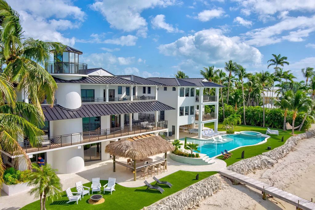 Wake up to waves lapping your private shore & breathtaking ocean views in this iconic Key Colony Beach retreat. 9 serene bedrooms, private pool, & endless entertainment space await in this coastal paradise. Luxury living redefined.