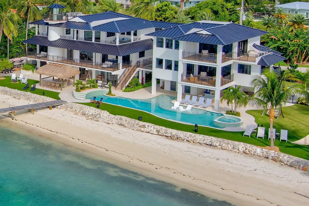 Wake up to waves lapping your private shore & breathtaking ocean views in this iconic Key Colony Beach retreat. 9 serene bedrooms, private pool, & endless entertainment space await in this coastal paradise. Luxury living redefined.