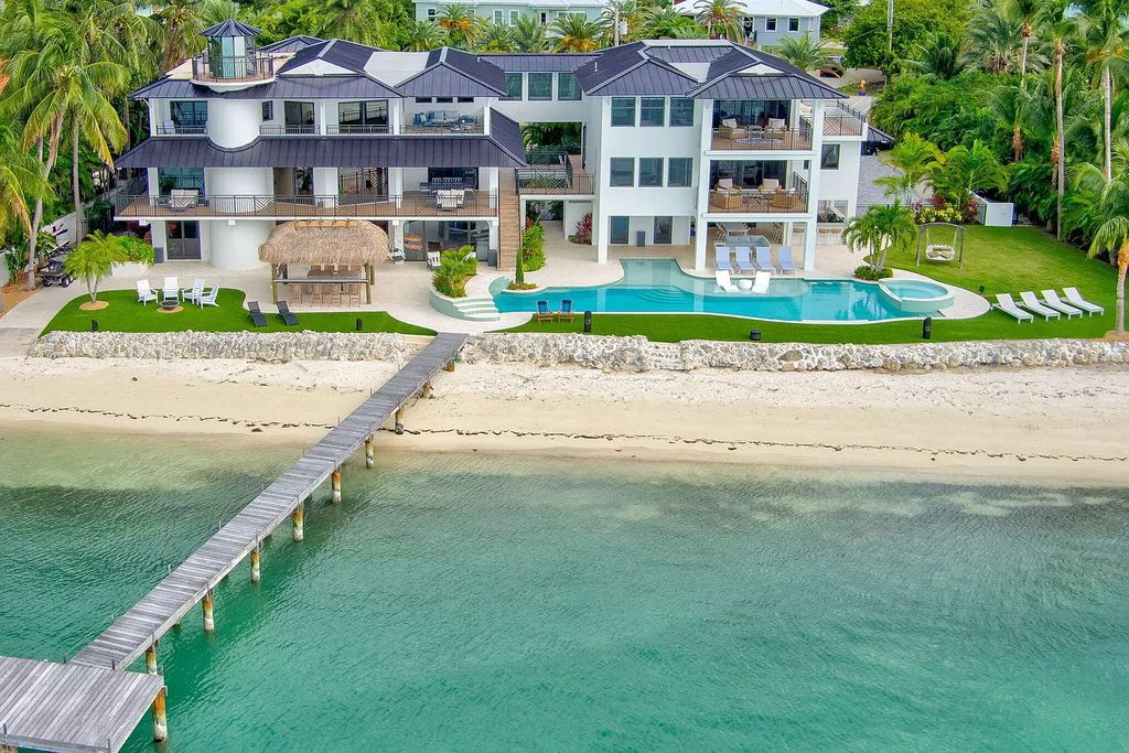 Wake up to waves lapping your private shore & breathtaking ocean views in this iconic Key Colony Beach retreat. 9 serene bedrooms, private pool, & endless entertainment space await in this coastal paradise. Luxury living redefined.