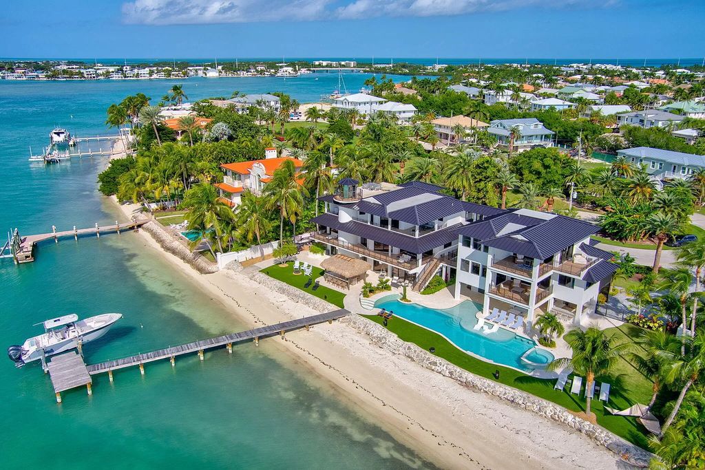 Wake up to waves lapping your private shore & breathtaking ocean views in this iconic Key Colony Beach retreat. 9 serene bedrooms, private pool, & endless entertainment space await in this coastal paradise. Luxury living redefined.