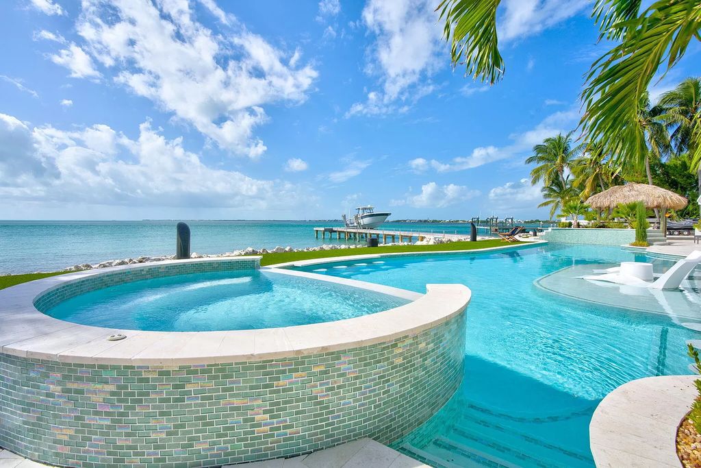 Wake up to waves lapping your private shore & breathtaking ocean views in this iconic Key Colony Beach retreat. 9 serene bedrooms, private pool, & endless entertainment space await in this coastal paradise. Luxury living redefined.