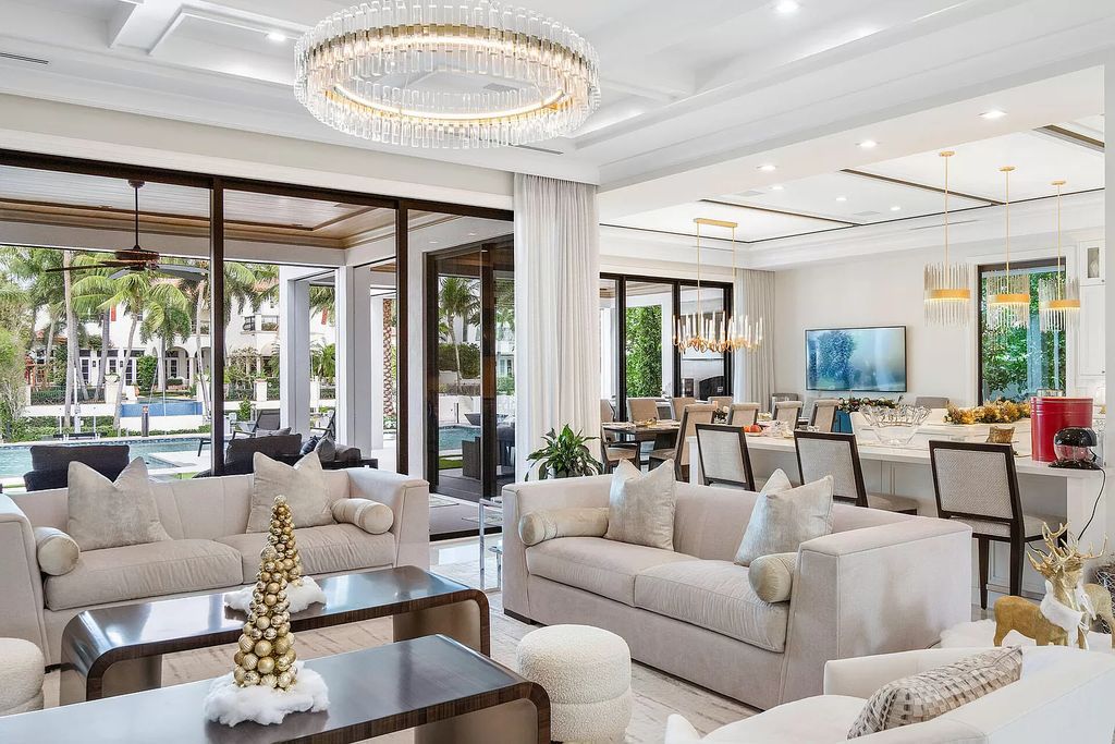 Set sail from your backyard in this custom 5-bedroom waterfront estate by SRD Building Corp. Luxurious living awaits with resort-style pool, dock, chef's kitchen, & smart home features. Explore 215 W Coconut Palm Rd, Boca Raton.