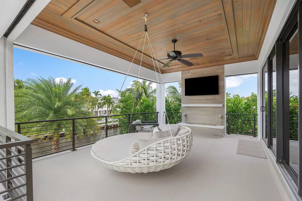 Set sail from your backyard in this custom 5-bedroom waterfront estate by SRD Building Corp. Luxurious living awaits with resort-style pool, dock, chef's kitchen, & smart home features. Explore 215 W Coconut Palm Rd, Boca Raton.