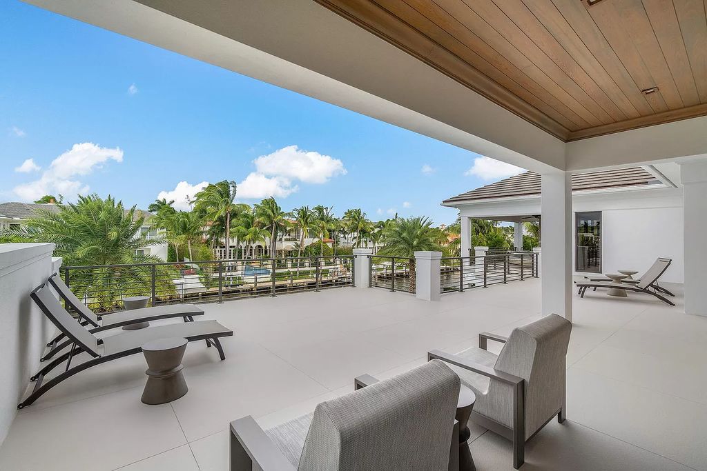 Set sail from your backyard in this custom 5-bedroom waterfront estate by SRD Building Corp. Luxurious living awaits with resort-style pool, dock, chef's kitchen, & smart home features. Explore 215 W Coconut Palm Rd, Boca Raton.