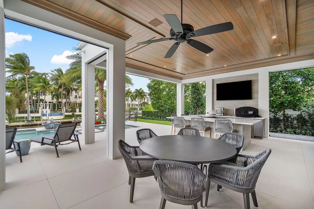 Set sail from your backyard in this custom 5-bedroom waterfront estate by SRD Building Corp. Luxurious living awaits with resort-style pool, dock, chef's kitchen, & smart home features. Explore 215 W Coconut Palm Rd, Boca Raton.