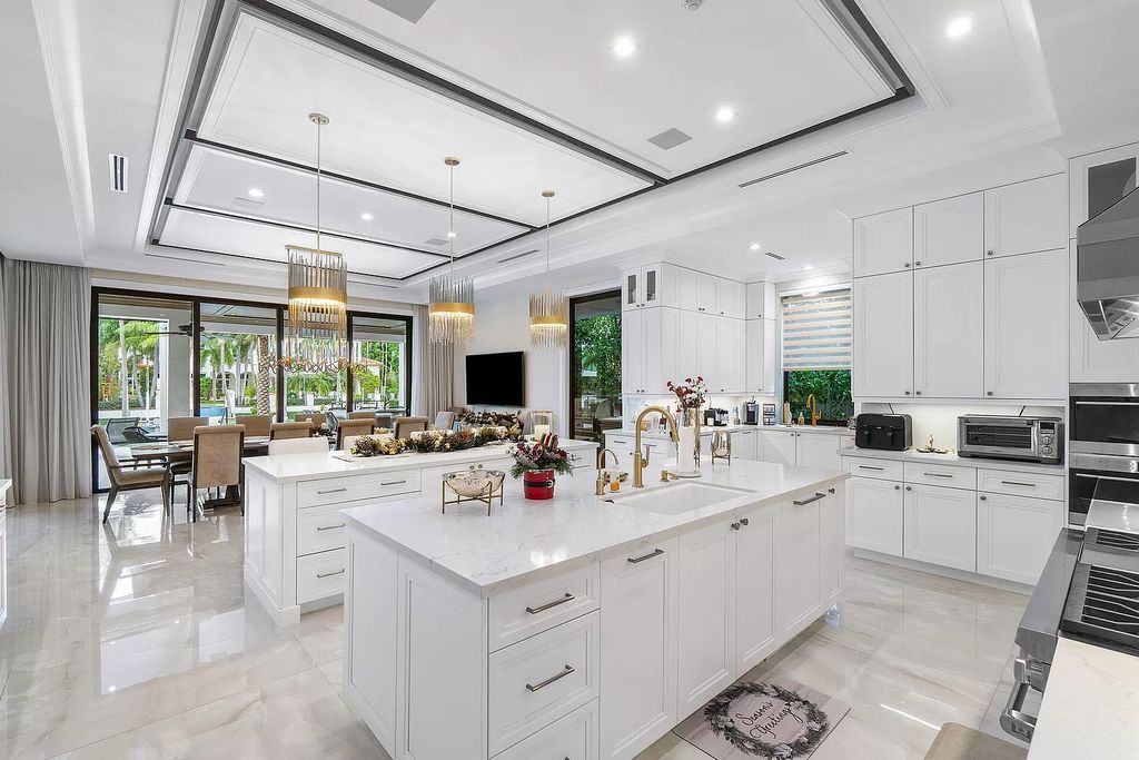 Set sail from your backyard in this custom 5-bedroom waterfront estate by SRD Building Corp. Luxurious living awaits with resort-style pool, dock, chef's kitchen, & smart home features. Explore 215 W Coconut Palm Rd, Boca Raton.