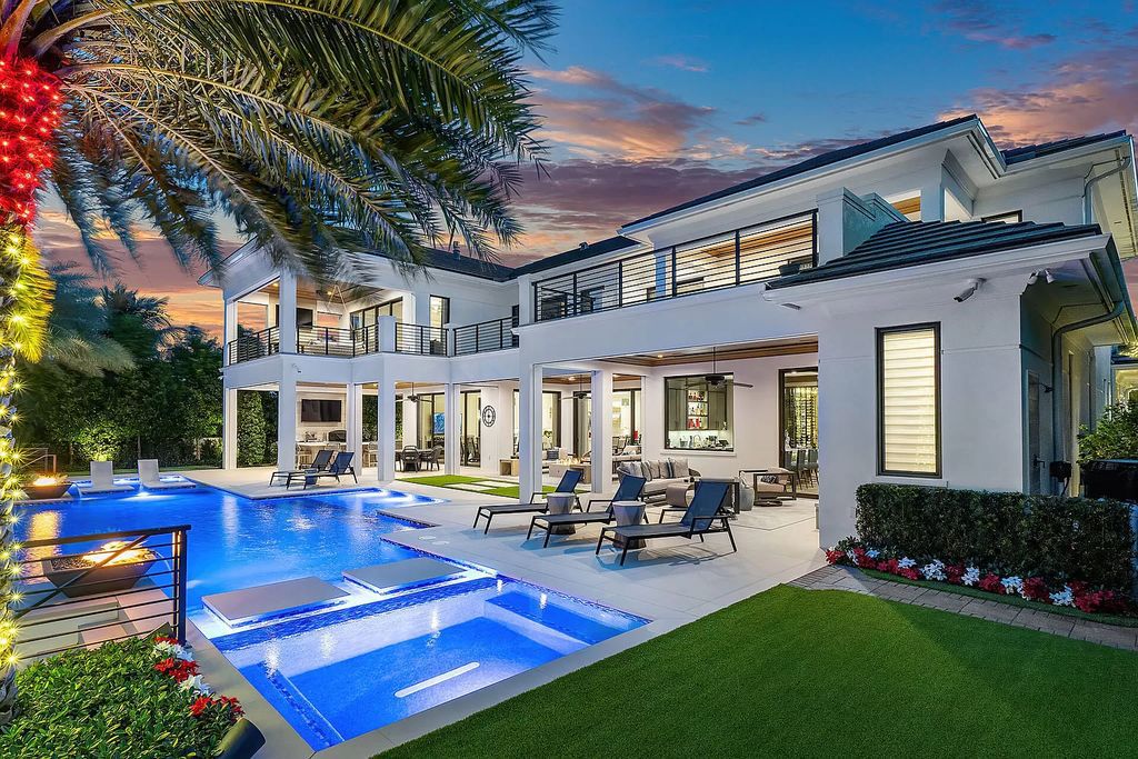 Set sail from your backyard in this custom 5-bedroom waterfront estate by SRD Building Corp. Luxurious living awaits with resort-style pool, dock, chef's kitchen, & smart home features. Explore 215 W Coconut Palm Rd, Boca Raton.