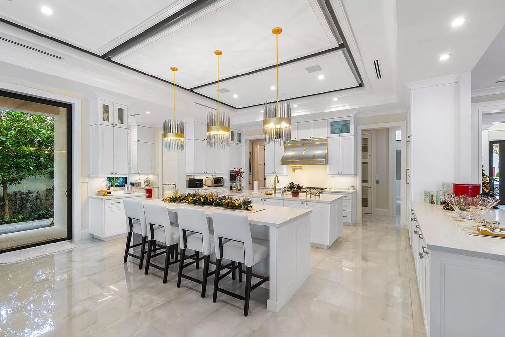 Set sail from your backyard in this custom 5-bedroom waterfront estate by SRD Building Corp. Luxurious living awaits with resort-style pool, dock, chef's kitchen, & smart home features. Explore 215 W Coconut Palm Rd, Boca Raton.