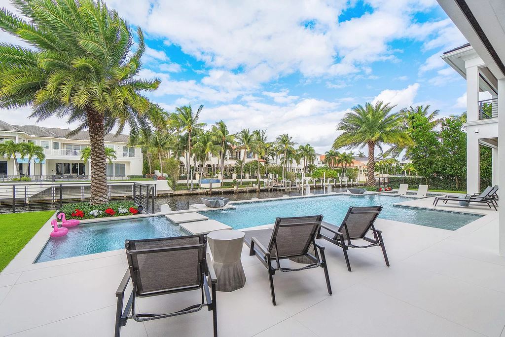 Set sail from your backyard in this custom 5-bedroom waterfront estate by SRD Building Corp. Luxurious living awaits with resort-style pool, dock, chef's kitchen, & smart home features. Explore 215 W Coconut Palm Rd, Boca Raton.