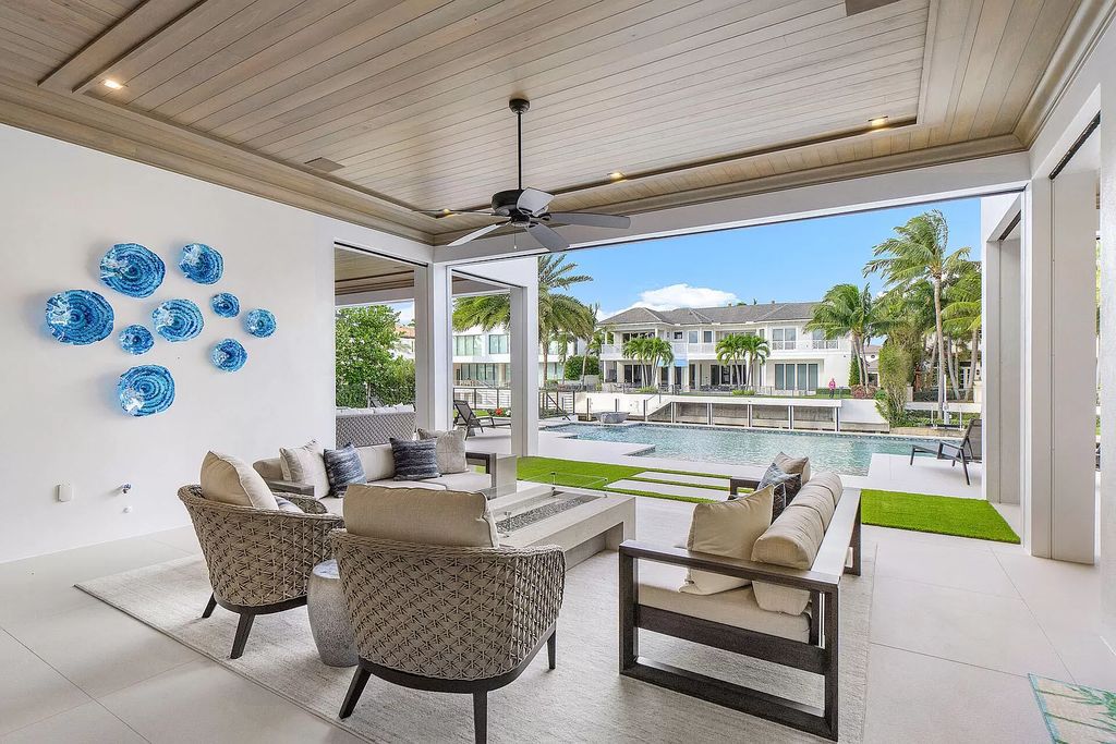 Set sail from your backyard in this custom 5-bedroom waterfront estate by SRD Building Corp. Luxurious living awaits with resort-style pool, dock, chef's kitchen, & smart home features. Explore 215 W Coconut Palm Rd, Boca Raton.