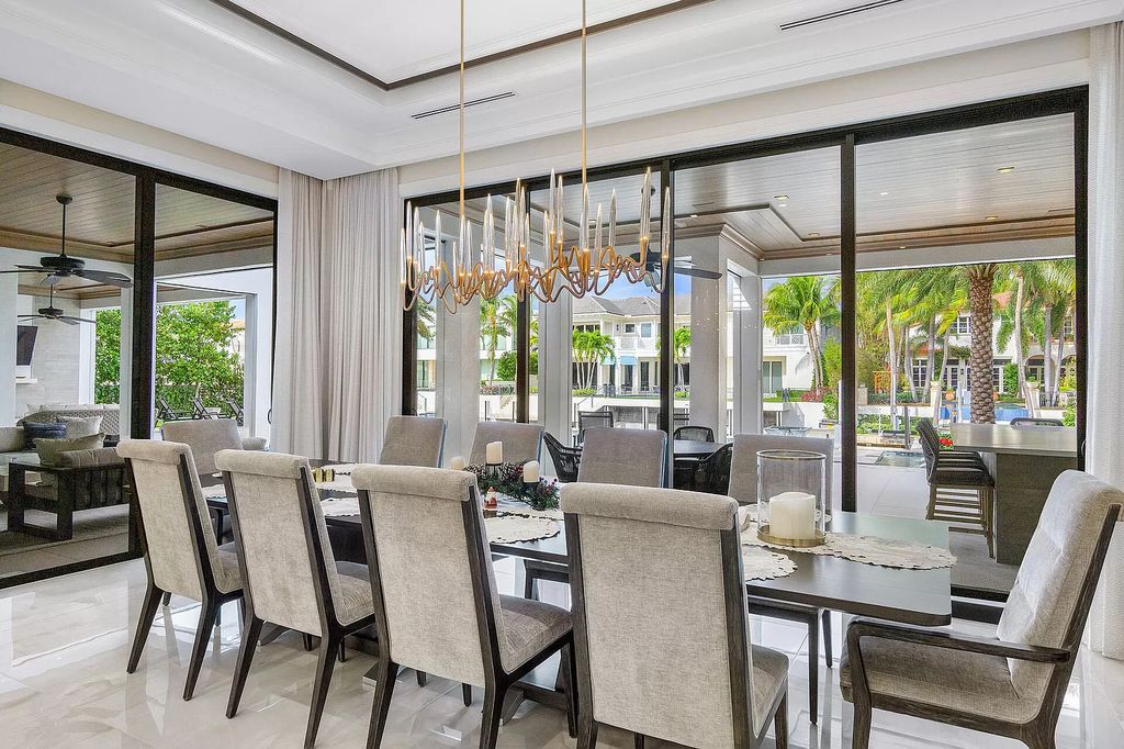 Set sail from your backyard in this custom 5-bedroom waterfront estate by SRD Building Corp. Luxurious living awaits with resort-style pool, dock, chef's kitchen, & smart home features. Explore 215 W Coconut Palm Rd, Boca Raton.