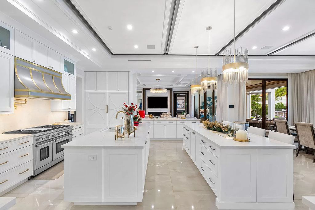 Set sail from your backyard in this custom 5-bedroom waterfront estate by SRD Building Corp. Luxurious living awaits with resort-style pool, dock, chef's kitchen, & smart home features. Explore 215 W Coconut Palm Rd, Boca Raton.