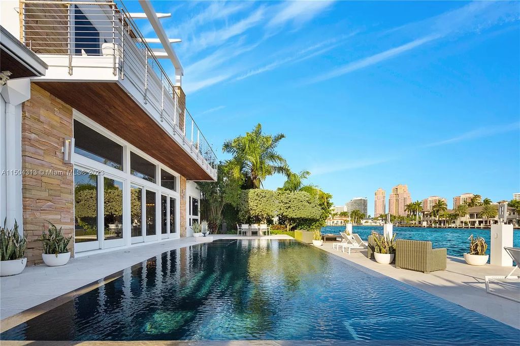 Step into a mid-century dream! This Fort Lauderdale estate boasts soaring ceilings, infinity pool & Intracoastal vistas. Master suite sanctuary, rooftop fireplace, potential expansion - experience Florida luxury redefined. 2110 Intracoastal Dr awaits.