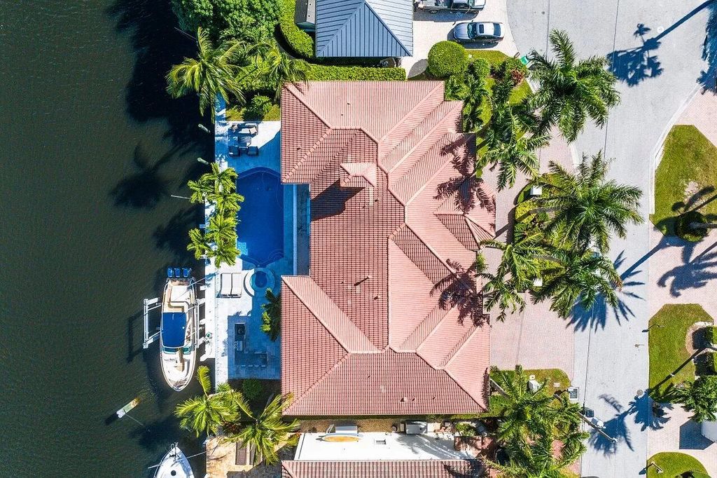 Experience the epitome of luxury living in this meticulously renovated 5-bedroom, 5.1-bathroom Delray Beach estate, boasting over 7,700 square feet of exquisite living space. Nestled within the prestigious waterfront community of Tropic Isle, this turnkey home is positioned on 100' of prime waterfront, offering unparalleled Intracoastal views and an unparalleled living experience.