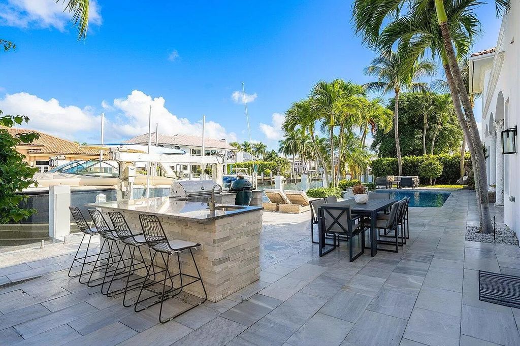 Experience the epitome of luxury living in this meticulously renovated 5-bedroom, 5.1-bathroom Delray Beach estate, boasting over 7,700 square feet of exquisite living space. Nestled within the prestigious waterfront community of Tropic Isle, this turnkey home is positioned on 100' of prime waterfront, offering unparalleled Intracoastal views and an unparalleled living experience.