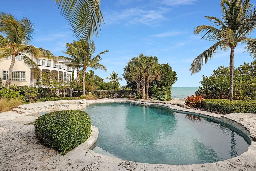 Escape to your own slice of paradise at this exquisite oceanfront estate in Islamorada. 450 feet of private beachfront, 8+ acres, heated pool and stunning Atlantic views - island living redefined!