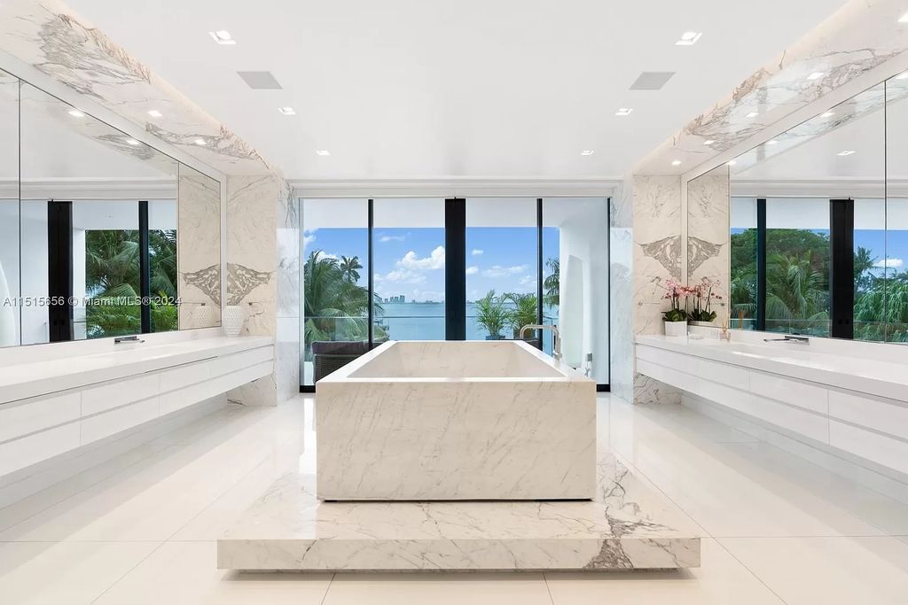 Discover elegance in this $42.5 million contemporary masterpiece by Jennifer Post on North Bay Road, Miami Beach. Atrium courtyard, infinity edge pool, rooftop pool, and a private dock with 105 feet of water frontage offer luxury living with breathtaking views.