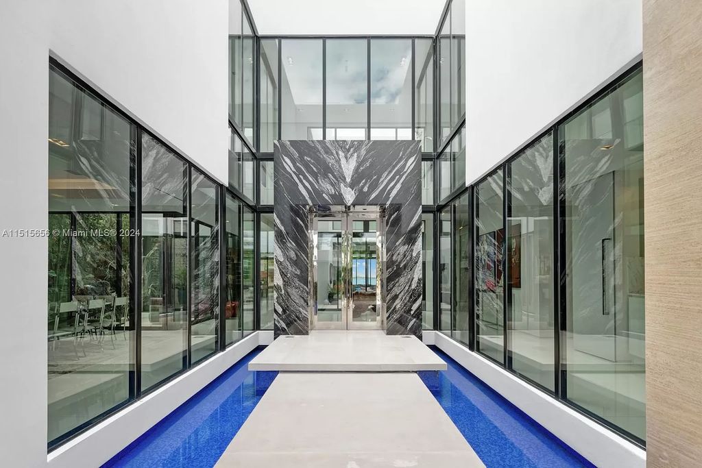 Discover elegance in this $42.5 million contemporary masterpiece by Jennifer Post on North Bay Road, Miami Beach. Atrium courtyard, infinity edge pool, rooftop pool, and a private dock with 105 feet of water frontage offer luxury living with breathtaking views.