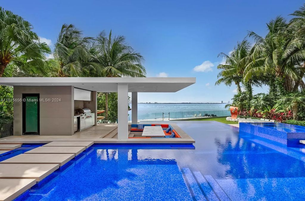 Discover elegance in this $42.5 million contemporary masterpiece by Jennifer Post on North Bay Road, Miami Beach. Atrium courtyard, infinity edge pool, rooftop pool, and a private dock with 105 feet of water frontage offer luxury living with breathtaking views.