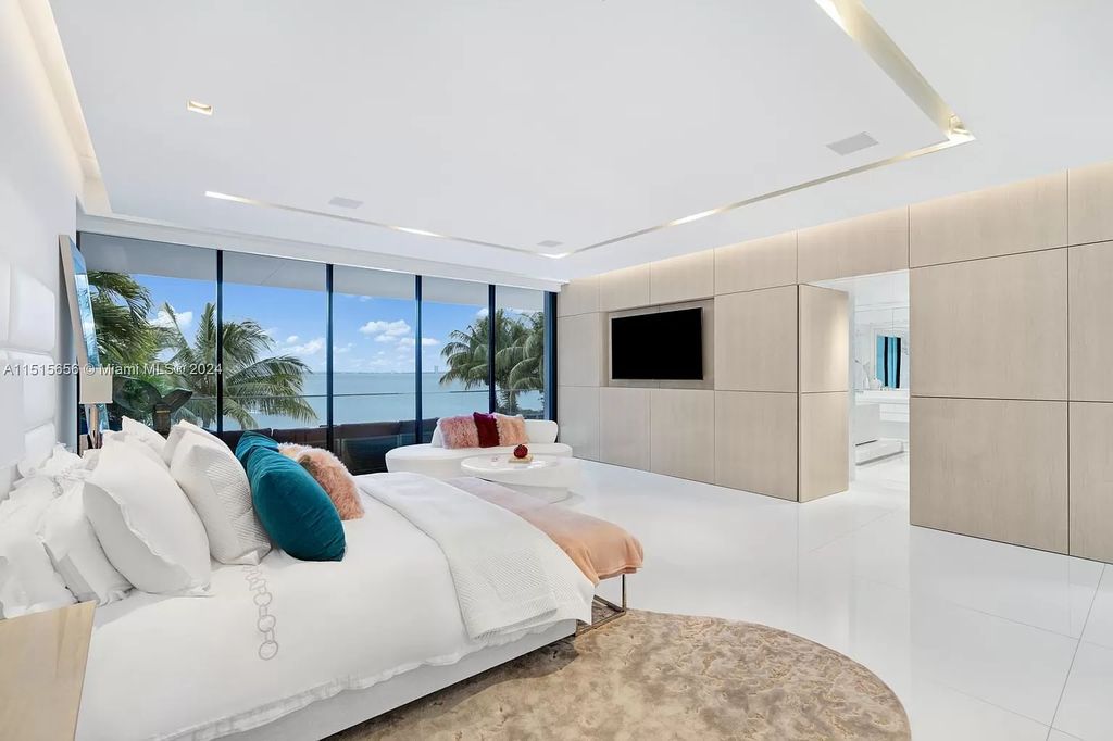 Discover elegance in this $42.5 million contemporary masterpiece by Jennifer Post on North Bay Road, Miami Beach. Atrium courtyard, infinity edge pool, rooftop pool, and a private dock with 105 feet of water frontage offer luxury living with breathtaking views.