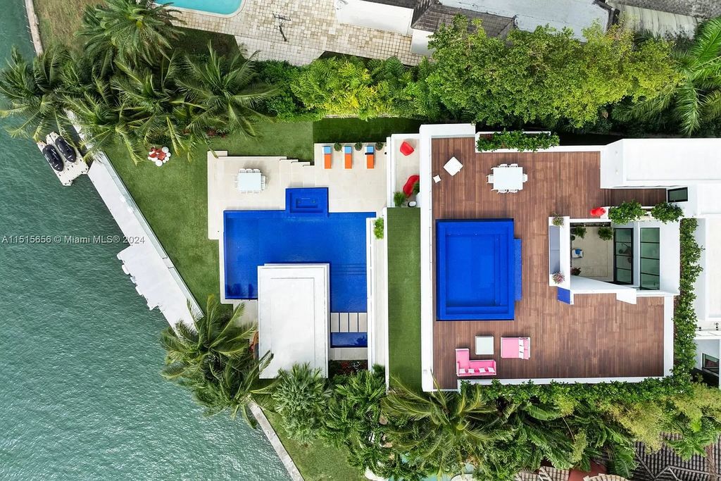 Discover elegance in this $42.5 million contemporary masterpiece by Jennifer Post on North Bay Road, Miami Beach. Atrium courtyard, infinity edge pool, rooftop pool, and a private dock with 105 feet of water frontage offer luxury living with breathtaking views.