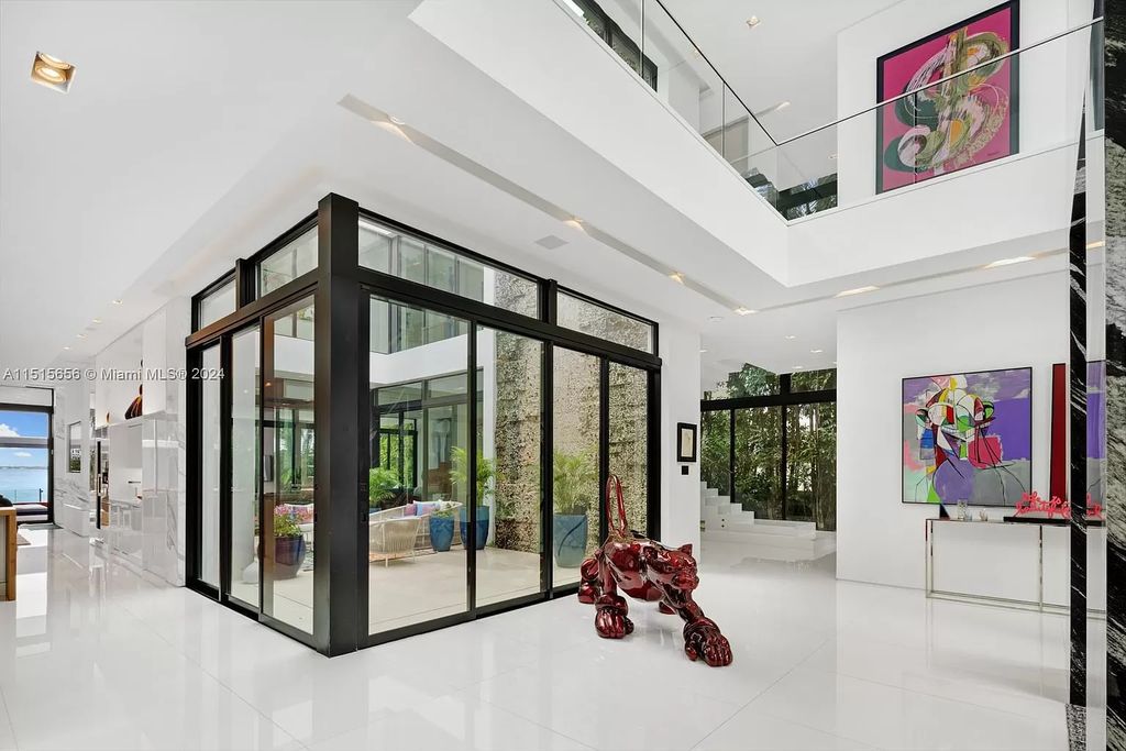 Discover elegance in this $42.5 million contemporary masterpiece by Jennifer Post on North Bay Road, Miami Beach. Atrium courtyard, infinity edge pool, rooftop pool, and a private dock with 105 feet of water frontage offer luxury living with breathtaking views.