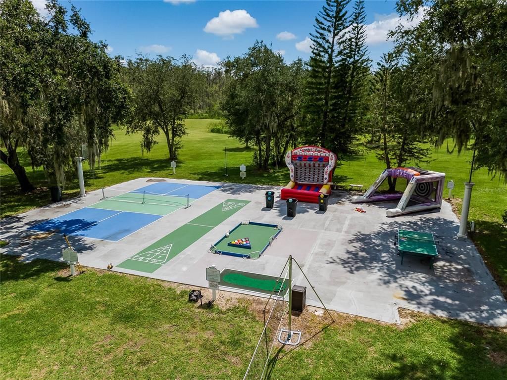 Escape to your own 54-acre playground! Fully furnished, income-generating Clermont Chain lakefront estate boasts 12 bedrooms, 3 kitchens, game rooms, arcade, pool and endless lake activities.