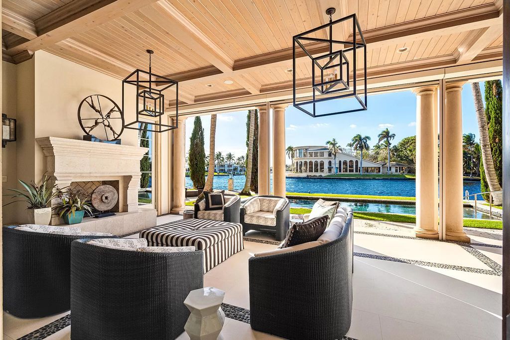 Gated Boca Raton estate with breathtaking Intracoastal and Royal Palm Grand Canal views. Tropical Georgian design with grand living spaces, gourmet kitchen, luxurious primary suite and resort-style pool/patio.