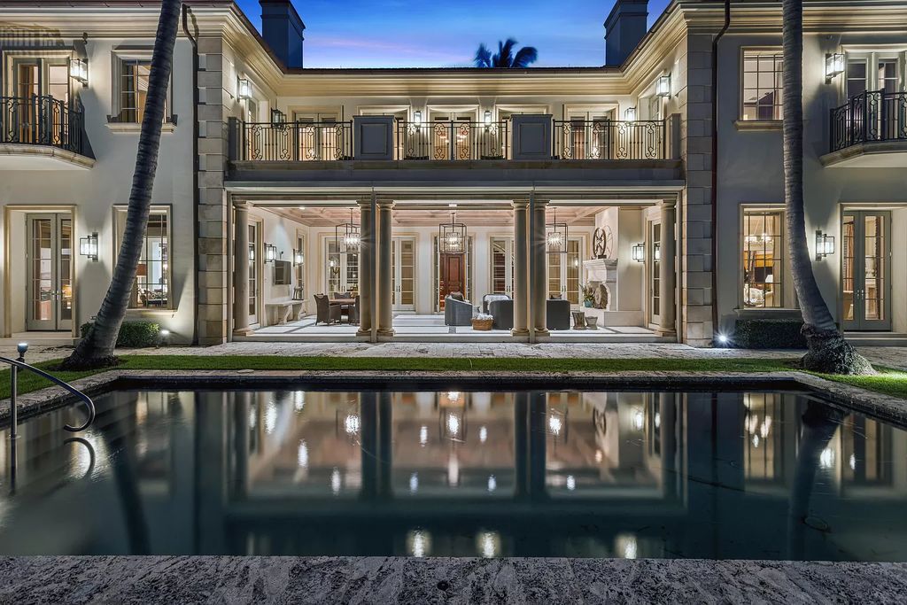 Gated Boca Raton estate with breathtaking Intracoastal and Royal Palm Grand Canal views. Tropical Georgian design with grand living spaces, gourmet kitchen, luxurious primary suite and resort-style pool/patio.