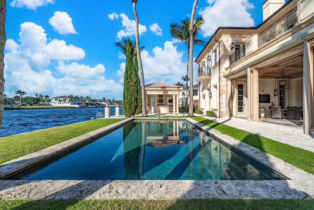 Gated Boca Raton estate with breathtaking Intracoastal and Royal Palm Grand Canal views. Tropical Georgian design with grand living spaces, gourmet kitchen, luxurious primary suite and resort-style pool/patio.