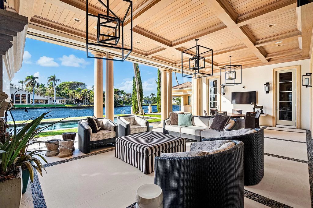 Gated Boca Raton estate with breathtaking Intracoastal and Royal Palm Grand Canal views. Tropical Georgian design with grand living spaces, gourmet kitchen, luxurious primary suite and resort-style pool/patio.