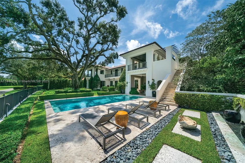 Experience unparalleled luxury in this meticulously designed 6-bedroom estate, boasting stunning golf course vistas, a chef's kitchen, resort-style pool, and prime location near Miami attractions.