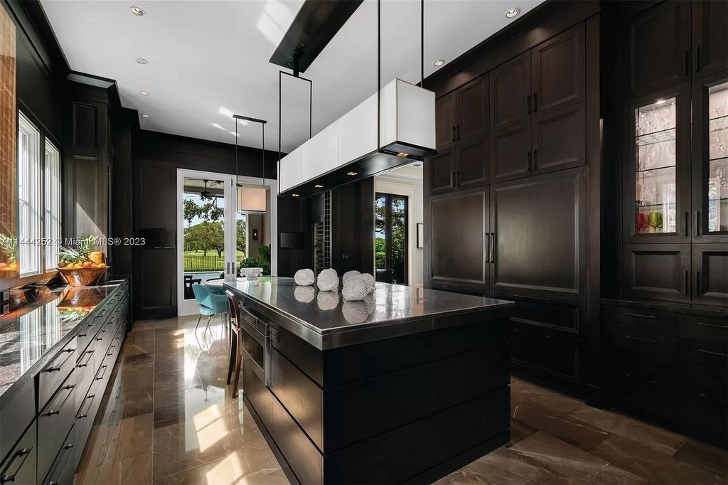 Experience unparalleled luxury in this meticulously designed 6-bedroom estate, boasting stunning golf course vistas, a chef's kitchen, resort-style pool, and prime location near Miami attractions.