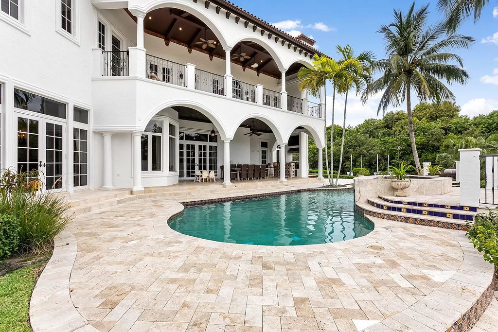 Experience the epitome of luxury waterfront living in this grand 5BR estate. Situated on an oversized lot in the prestigious Harbour Isles community, this home boasts over 10,000 sqft of living space, private preserve views, and a deep-water dock.