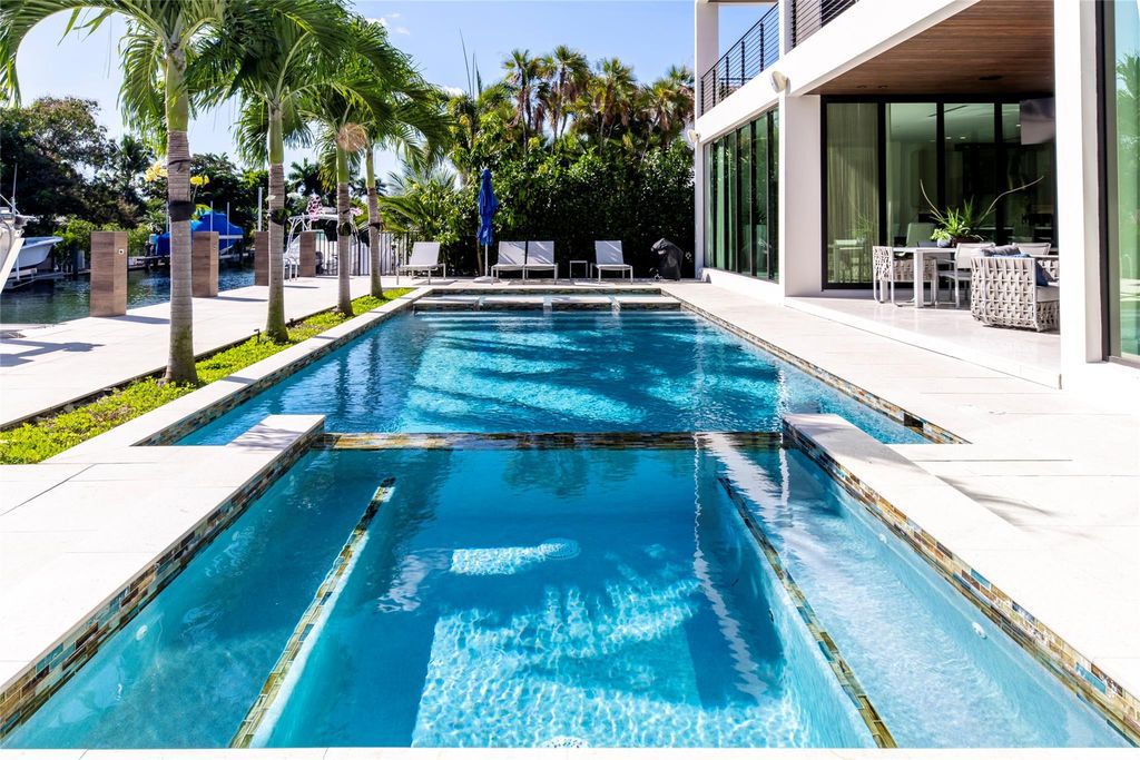 Unparalleled luxury awaits in this newer custom Las Olas Isles stunner. Exquisite contemporary architecture, 25ft ceilings and seamless indoor/outdoor living. Poggenpohl kitchen, wine cellar, media room/gym and 6 ensuite bedrooms. Resort-style pool, dock and city utilities. Jeff Hendricks masterpiece.