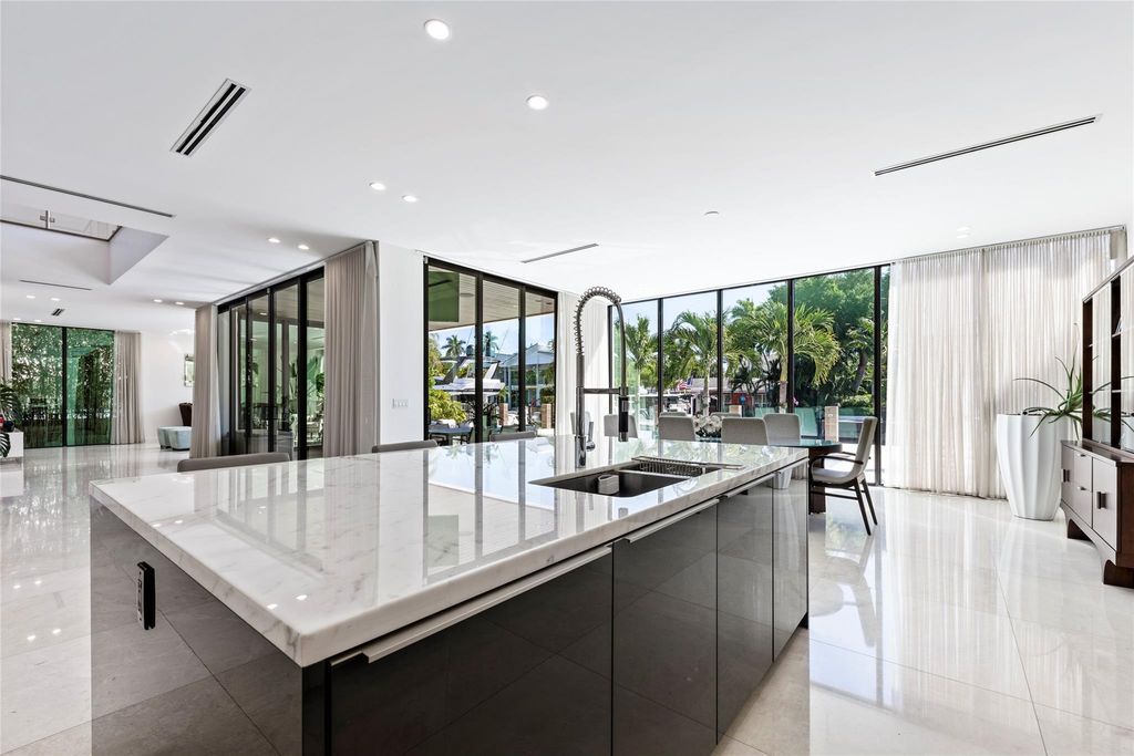 Unparalleled luxury awaits in this newer custom Las Olas Isles stunner. Exquisite contemporary architecture, 25ft ceilings and seamless indoor/outdoor living. Poggenpohl kitchen, wine cellar, media room/gym and 6 ensuite bedrooms. Resort-style pool, dock and city utilities. Jeff Hendricks masterpiece.