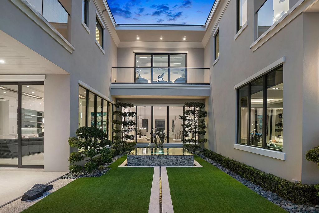 Unparalleled luxury awaits at 290 South Maya Palm Drive: 5 bedrooms, 6.2 baths, 9,000+ sqft of coastal-glam living with 140' waterfront, infinity pool and resort-style backyard. Agate walls, marble fireplaces and designer details. Boca Raton living redefined.